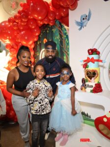 Kandi Burruss and Todd Tucker stand with their children, Ace and Blaze (dressed as a princess), at Blaze's Snow White-themed 6th birthday party, showcasing successful Kandi Todd Co-Parenting after their divorce announcement.